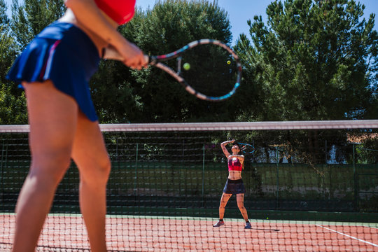 Female tennis players haying a match on court