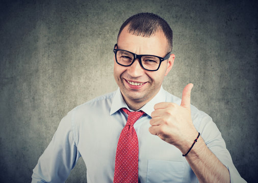 Businessman showing thumbs up hand gesture