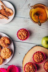 Oatmeal muffins with apple and cup of green tea.