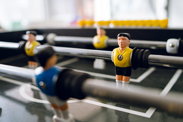 Close up on players of Table football soccer kicker foosball top-table game - obrazy, fototapety, plakaty