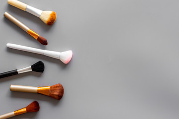 Instruments for make up with brushes on gray background top view mock up