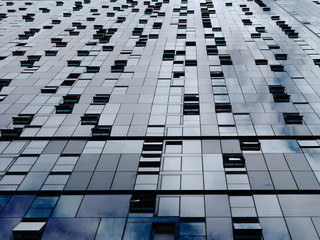 Abstract metallic background. Diminishing perspective of modern building wall and windows.  