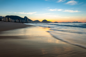 Wave movement on Copacabana beach in Rio de Janeiro with the Sugarloaf mountain in the background...