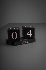 A black block calendar display 4th of July