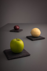 A Green Apple, Lemon and Plum fruits 