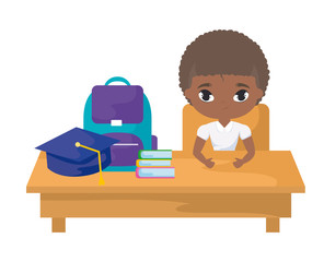student boy afro sitting in school desk with supplies education