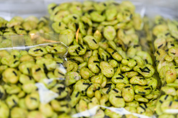 Packages of roasted green soybeans soy edamame with wasabi and seaweed in Tsukiji outer street fish market in Ginza Tokyo, Japan