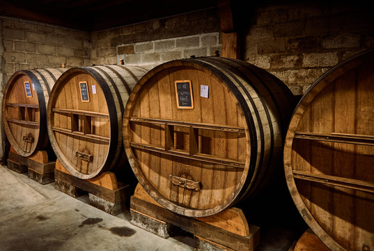 Old oak cask of calvados in a cellar in Normandy, France