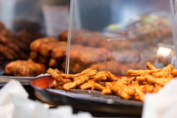 Closeup of retail display showing grill and battered fried grilled fish in Tsukiji outer morning market in Ginza, Tokyo Japan