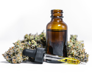 CBD Hemp Oil with Marijuana Buds on White Background