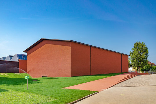Vitra Schaudepot, minimal architecture with beautiful brick exterior facade designed by Herzog & de Meuron, located in Vitra Campus, Swiss furniture manufacturer in Weil am Rhein, Germany.