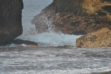 waves of sea water between rocks