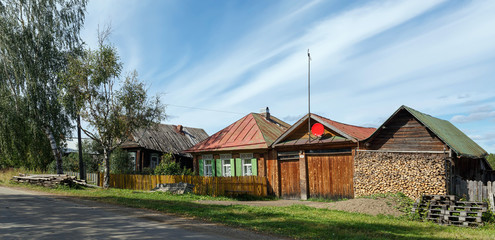 Fototapeta na wymiar Russian village in summer. Panorama of the village street. Village of Visim, Sverdlovsk region, Russia.