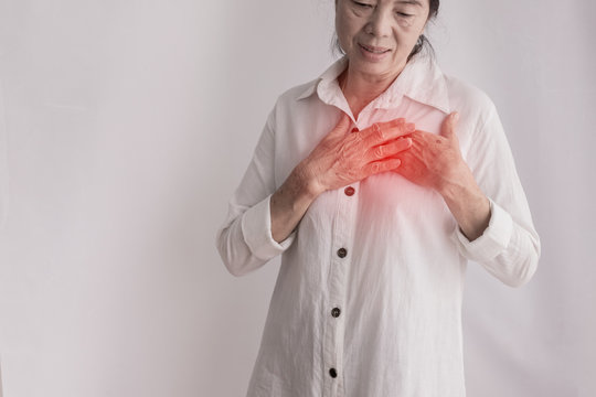 Asian Elderly Woman Having Chest Pain On Isolated White Background.