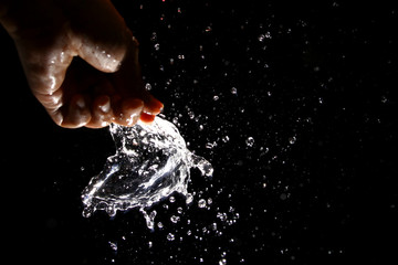 Popping the water balloon on black background