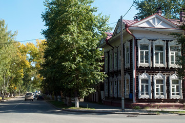 Tomsk Russia, street scene with traditional wooden home with white window tracery