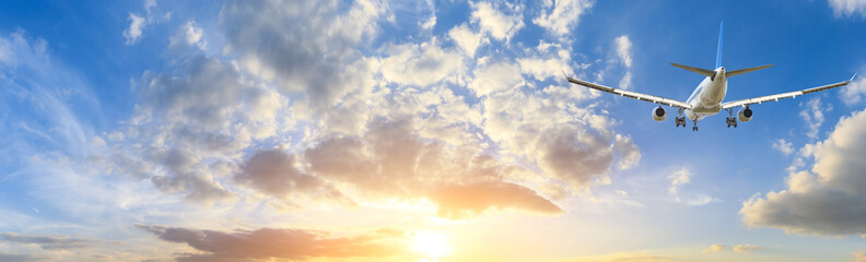 Airplane in the sky at sunrise © ABCDstock