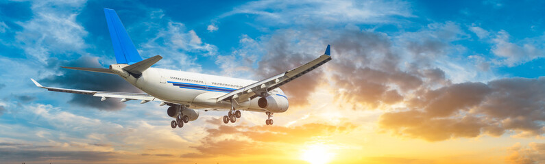 Airplane in the sky at sunrise