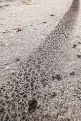 Dirty tire track on asphalt