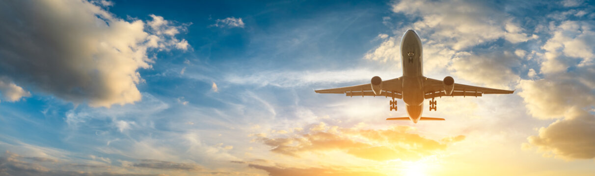 Airplane in the sky at sunrise © ABCDstock