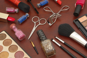 Various makeup products on wooden background close up