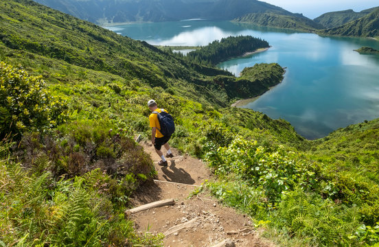 Man Hiking Down to Lagoa do Fogo or Lake of Fire in Sao Miguel, Azores, Portugal
