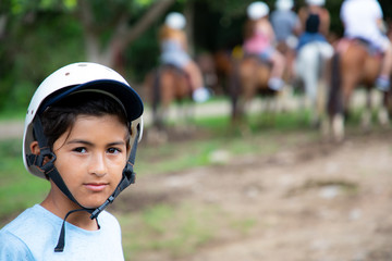Fototapeta na wymiar Boy on a horse riding tour at an adventure park in Guanacaste in Costa Rica