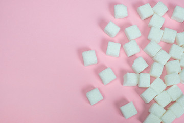 Sugar cubes  on a pink background.Sugar with copy space.