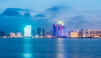 Naklejka na ściany i meble Nightscape Skyline of Urban Architecture along Qingdao Coastal Line..