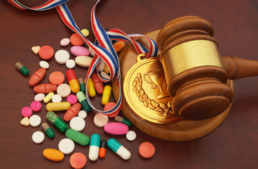 Judge gavel, gold medal and doping on table, sport arbitration court concept. - obrazy, fototapety, plakaty