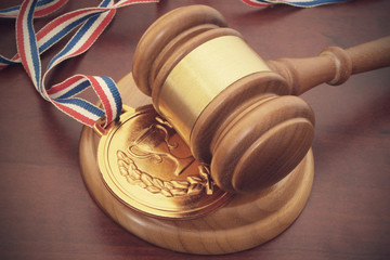 Medal and wooden judge gavel