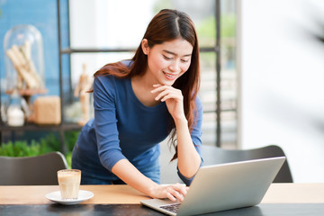 Asian business girl working and drinking coffee in cafe