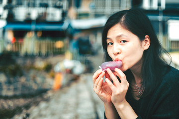 Woman eating traditional chinese sweet sticky rice cake