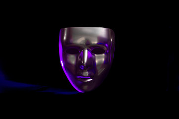 chrome face mask on black with magenta key light