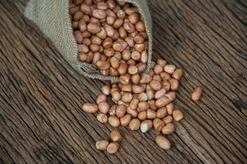 Peanut in sack on wooden table