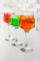 Glasses of tasty summer cocktails on table