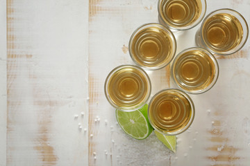 Obraz na płótnie Canvas Shots of tequila on wooden background