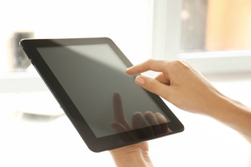 Woman with tablet computer indoors