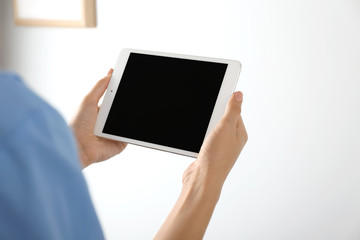 Nurse with tablet computer in clinic