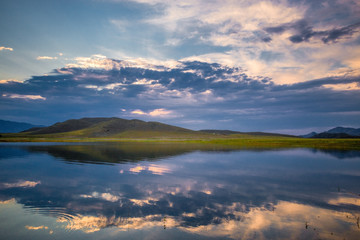 amazing view of sky over rippled surface of azure sea at sunrise
