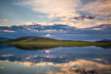 picturesque view of endless seascape with sunset reflecting on mirror water surface
