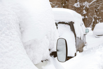 a number of cars covered with snow on the roof