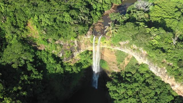 Aerial view of a beautiful view of the waterfall on the island of Mauritius from a bird's eye view on a sunny summer day. Concept of tourism in reserved places. 