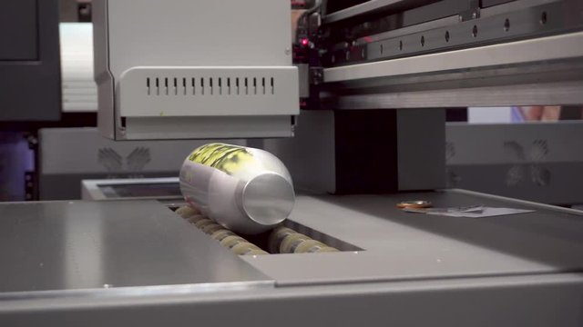 Automatic UV printing process on bottle. UV printer working.