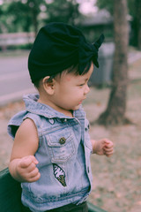 Happy little girl in autumn park. Fashion Kid outdoor.