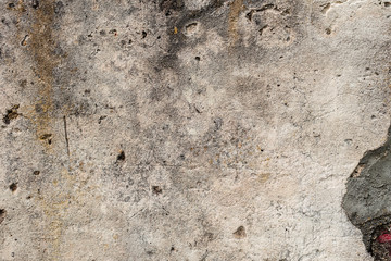 Texture of a concrete wall with cracks and scratches which can be used as a background