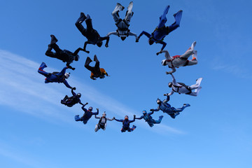 Formation skydiving. A group of skydivers is in the amazing sky.