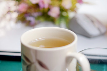 Soft blurred tea cup with flowerand light in morning