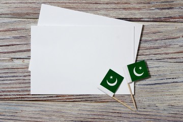 independence day of Pakistan. August 14. the concept of freedom, independence and patriotism. mini flags with sheets of white paper on wooden background. horizontal