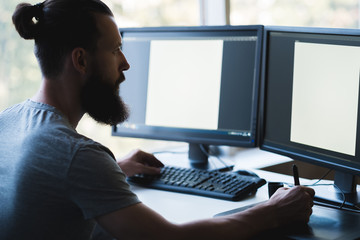 Web graphic design. Creative illustrator drawing with stylus on digital art board. Mockup double screen background. Copy space.